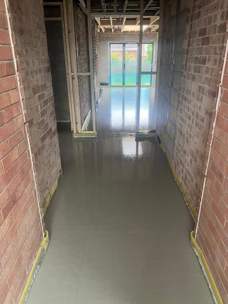 flow screed floor in a hallway of an unfinished building